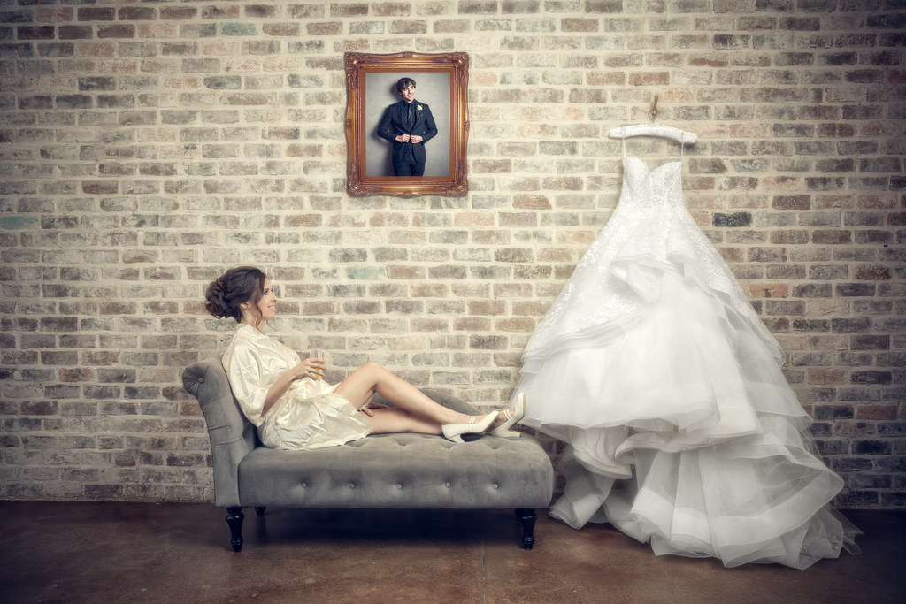 Bride relaxing beside her wedding dress in a Houston bridal suite